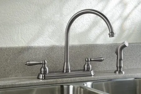 New kitchen faucet installed on a stainless sink